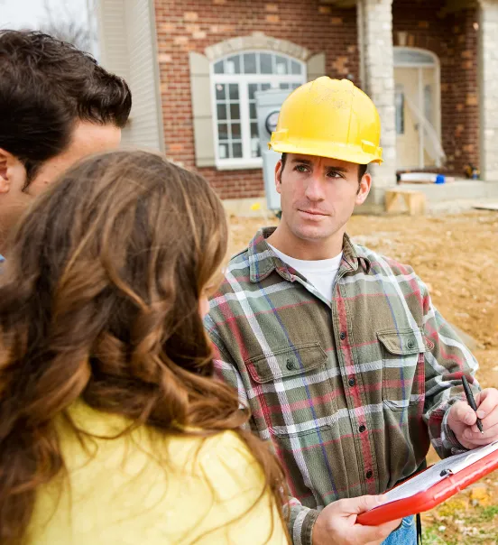 Los Angeles ADU consultation with homeowner and contractor reviewing backyard construction plans
