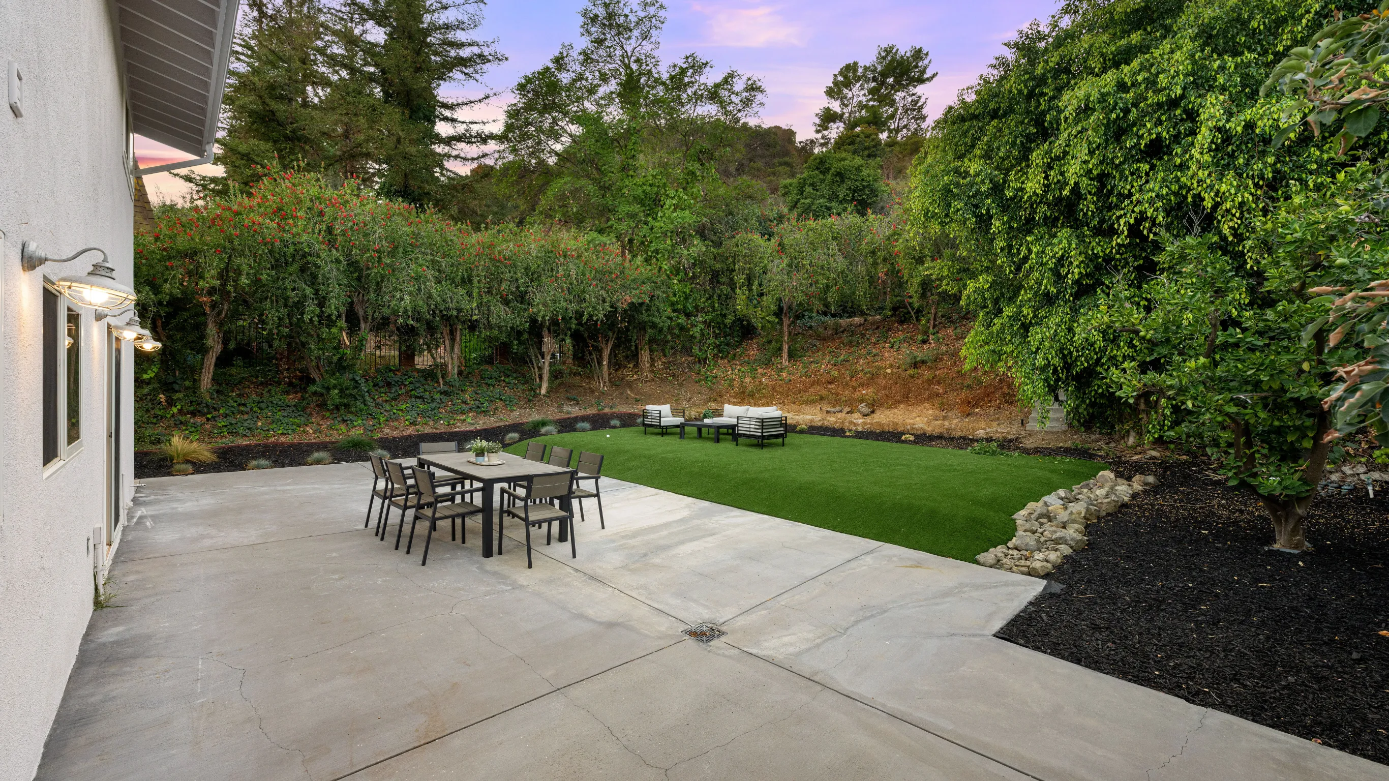 Before image of a detached ADU project in Los Angeles showing an empty backyard patio area with lawn, seating, and open space before detached ADU installation