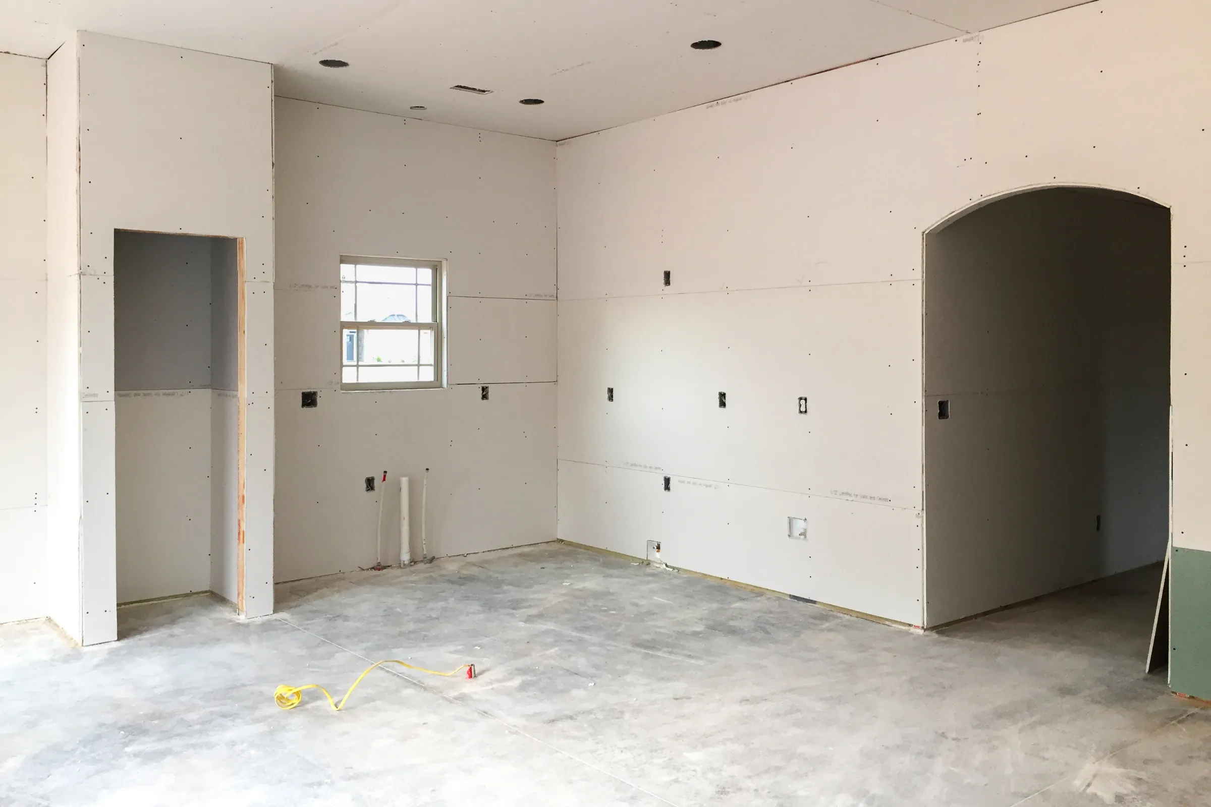 ADU interior buildout in Los Angeles with drywall installation, electrical rough-ins, and unfinished living space construction