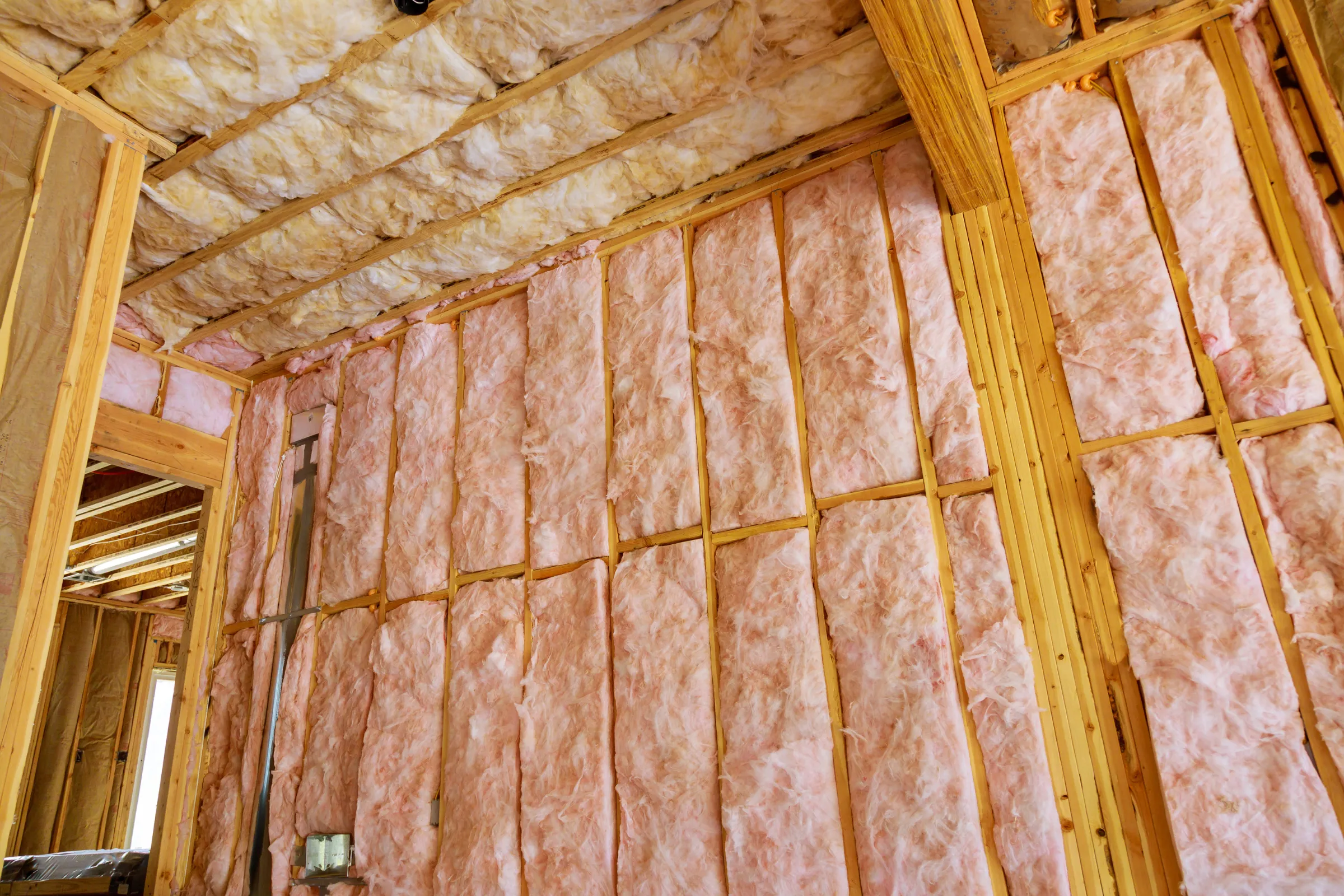 ADU interior buildout in Los Angeles showing insulation rough-in, wood framing, ceiling insulation, and unfinished interior construction