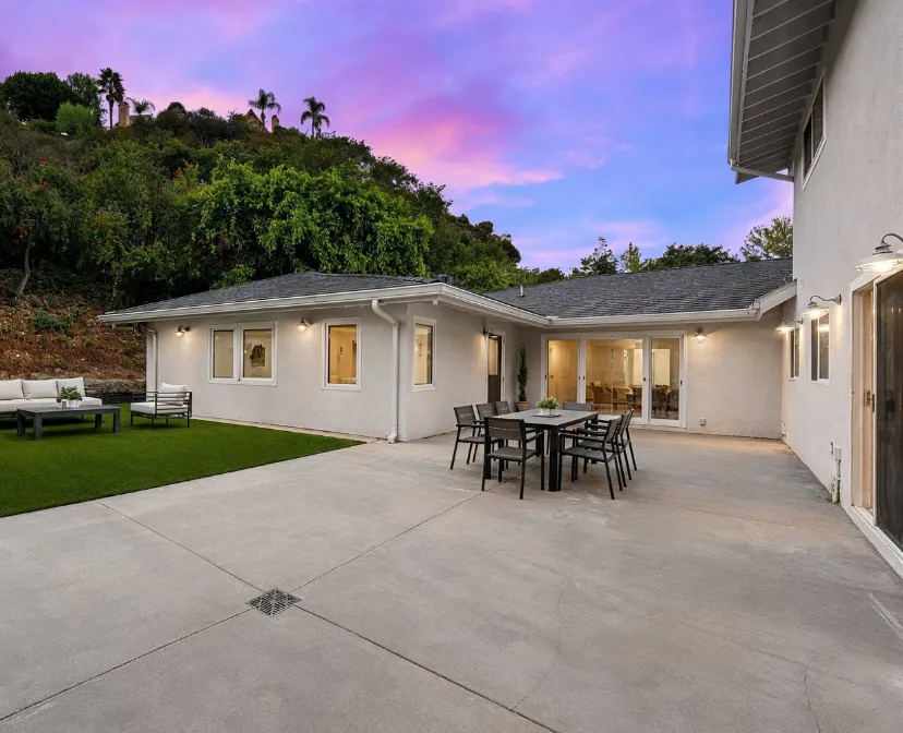 Attached ADU builders in Los Angeles finished backyard attached ADU project with matching stucco exterior, patio area, and integrated home addition